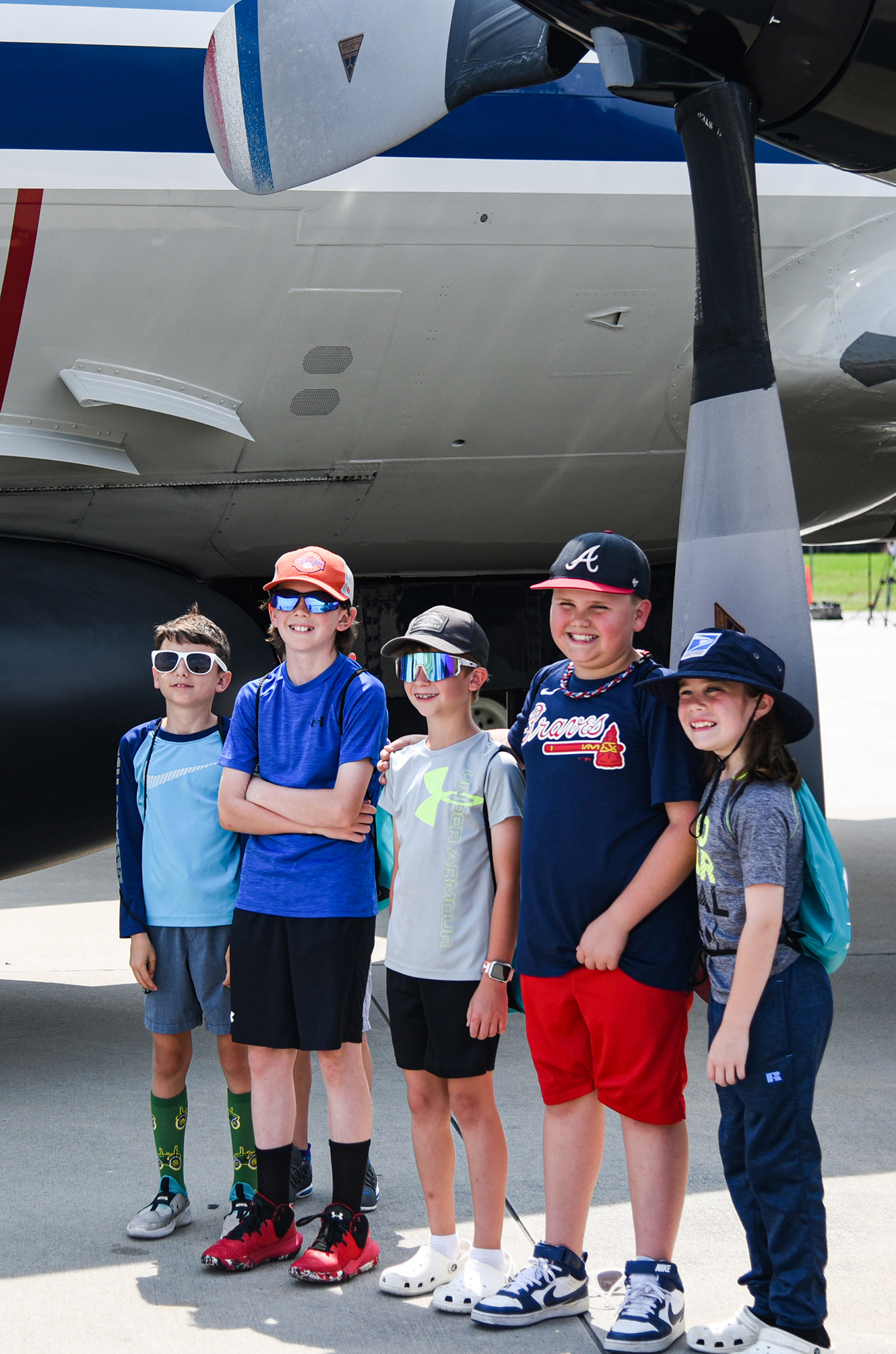 students underneath propellers