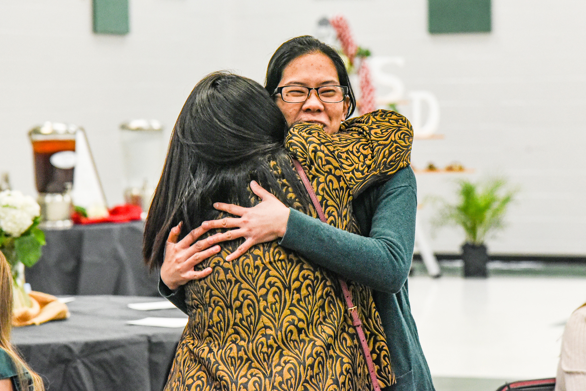two teachers hugging