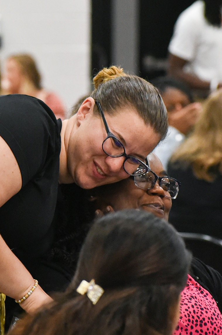 two teachers hugging
