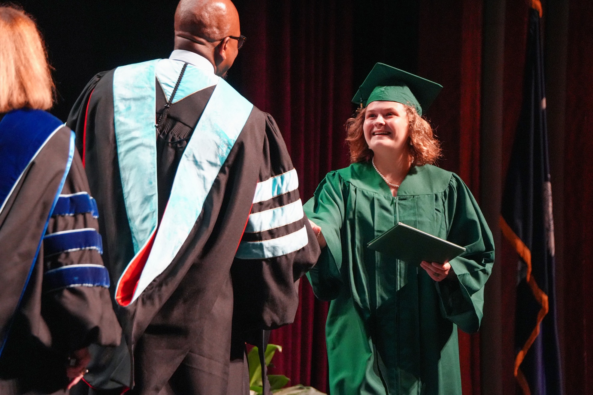 graduate speaking at podium