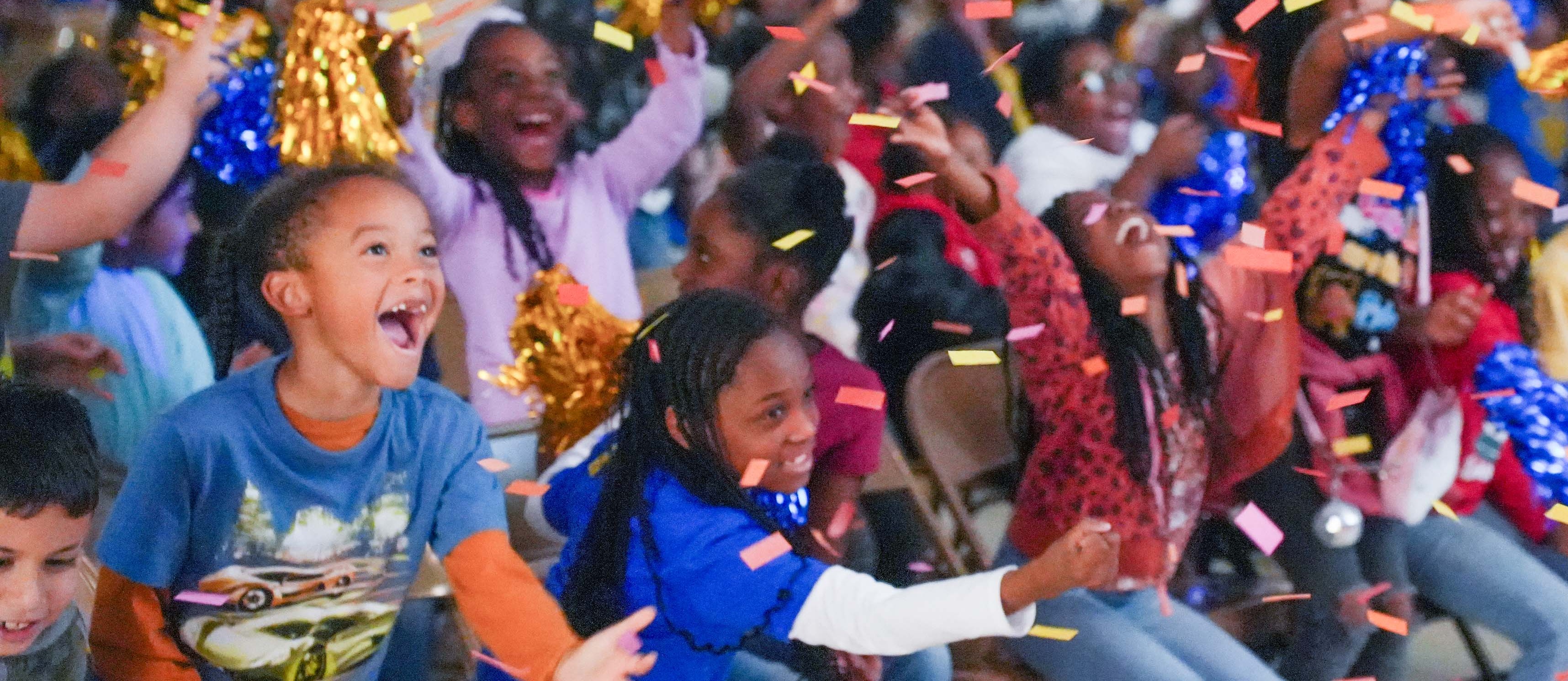 students cheering with confetti