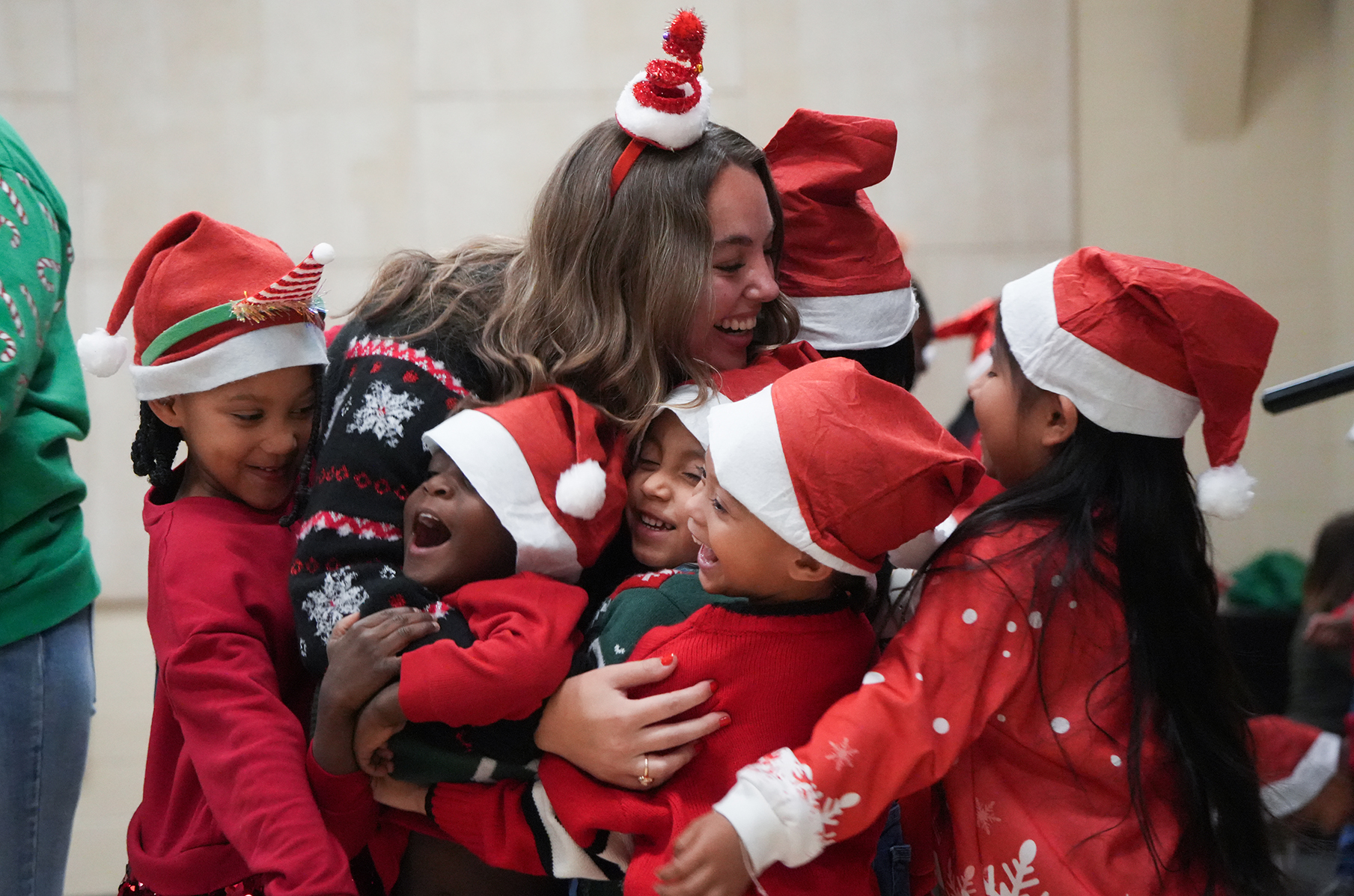 students group hugging teacher