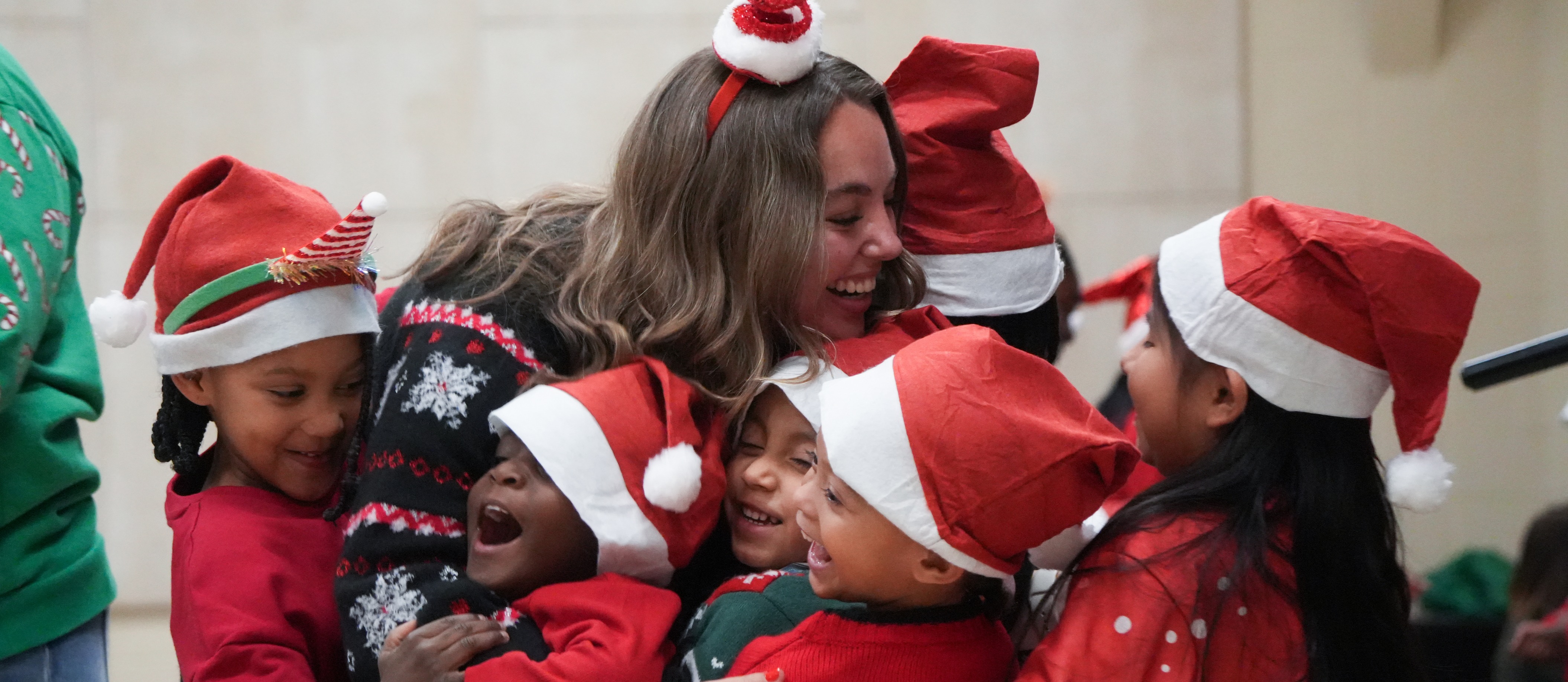 students hugging teacher