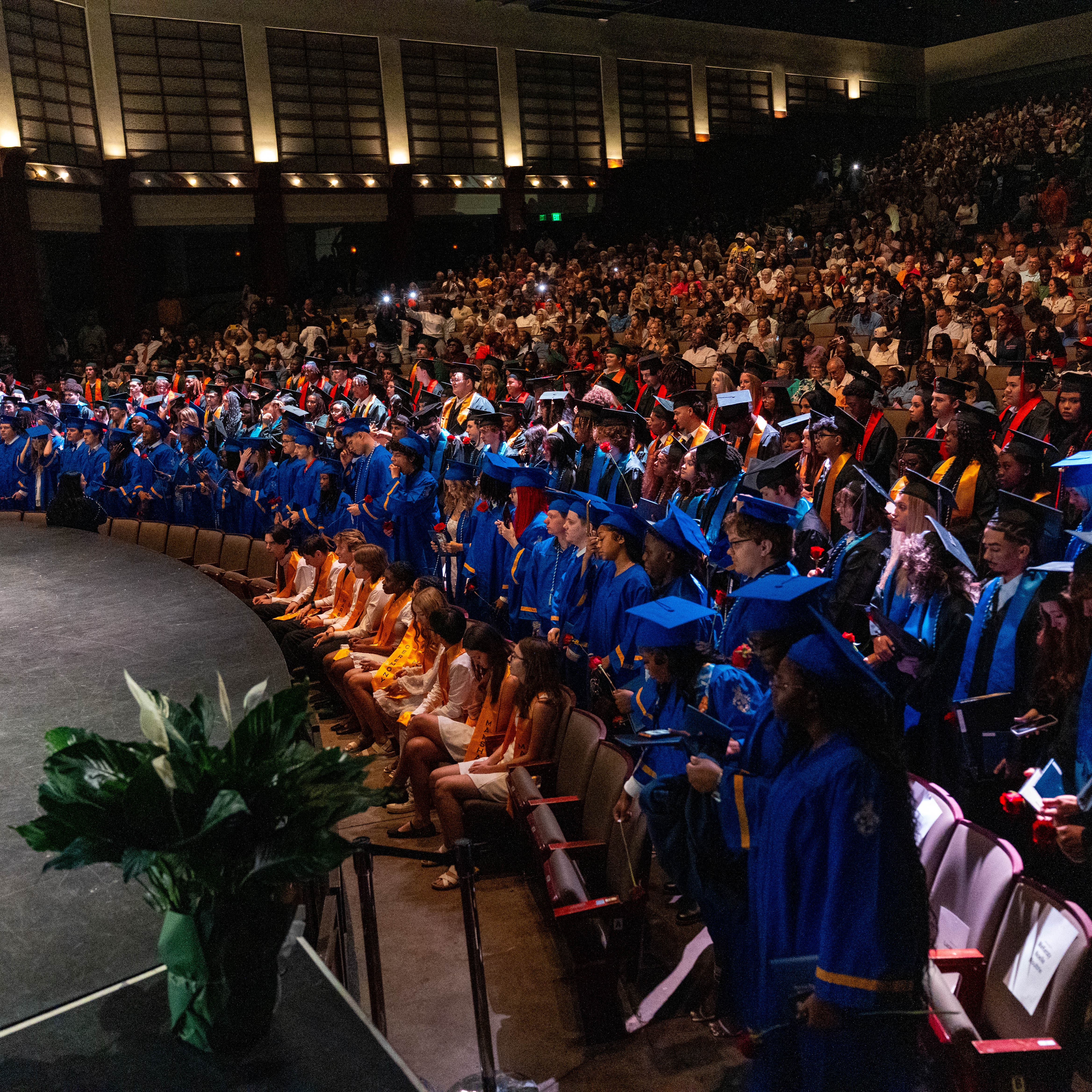 students group hugging teacher