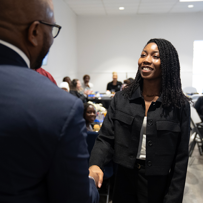 student being congratulated at MLK Luncheon