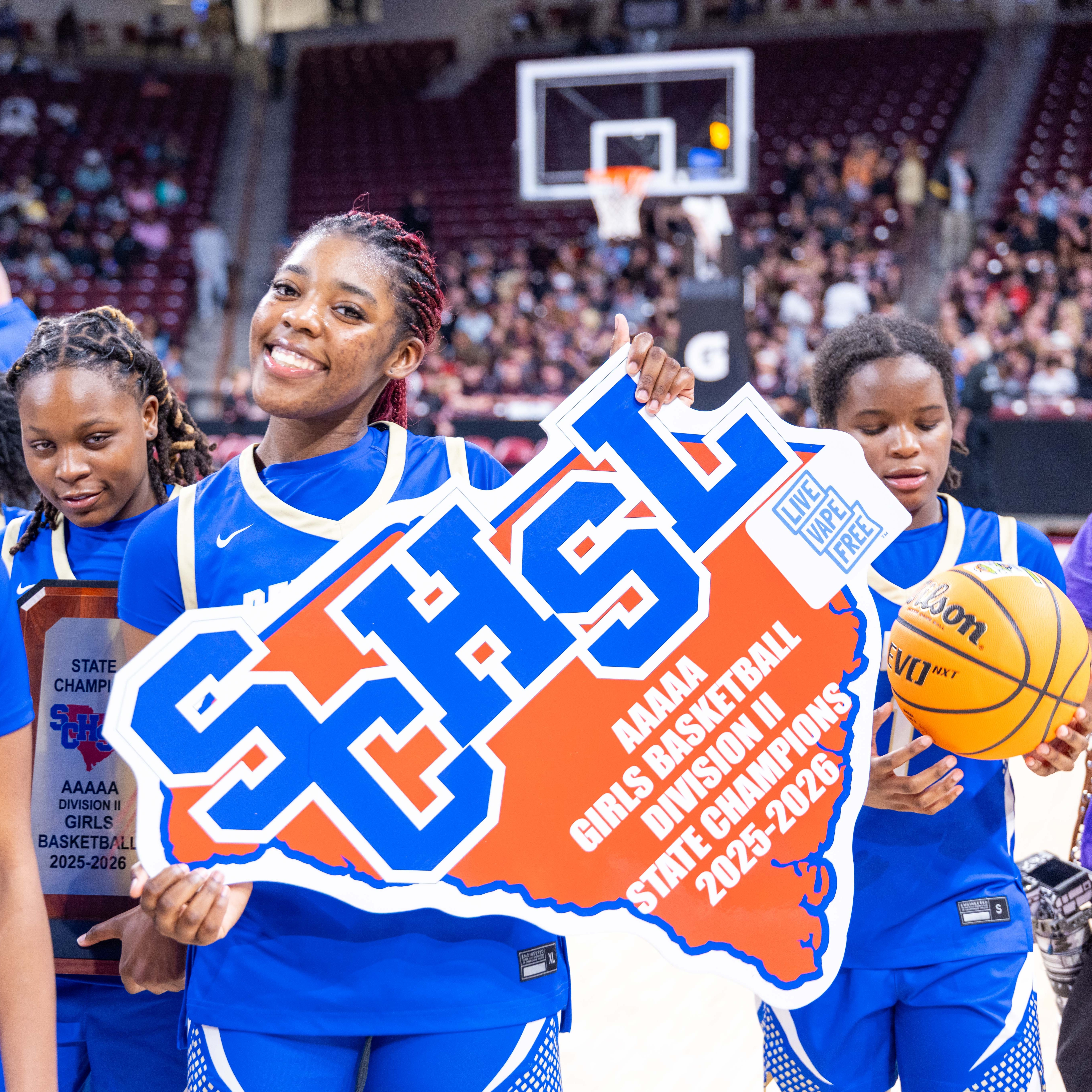 BHS girls basketball players with state title sign