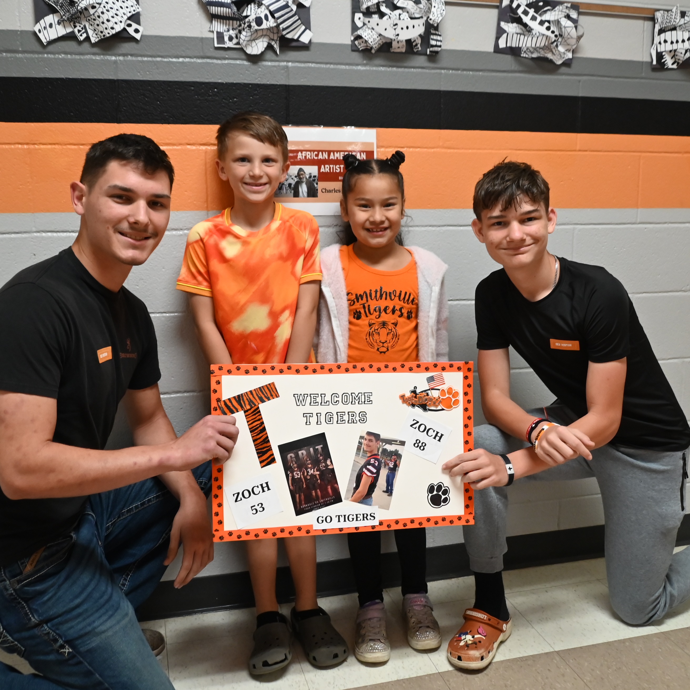 students holding sign for celebrity readers