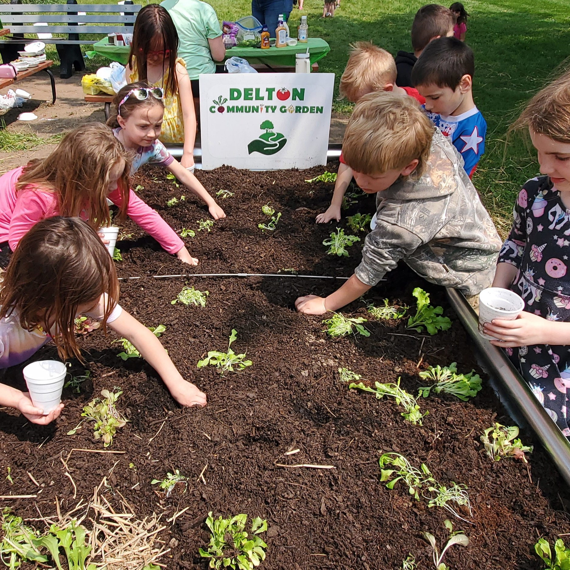 Young students planting in the community garden.