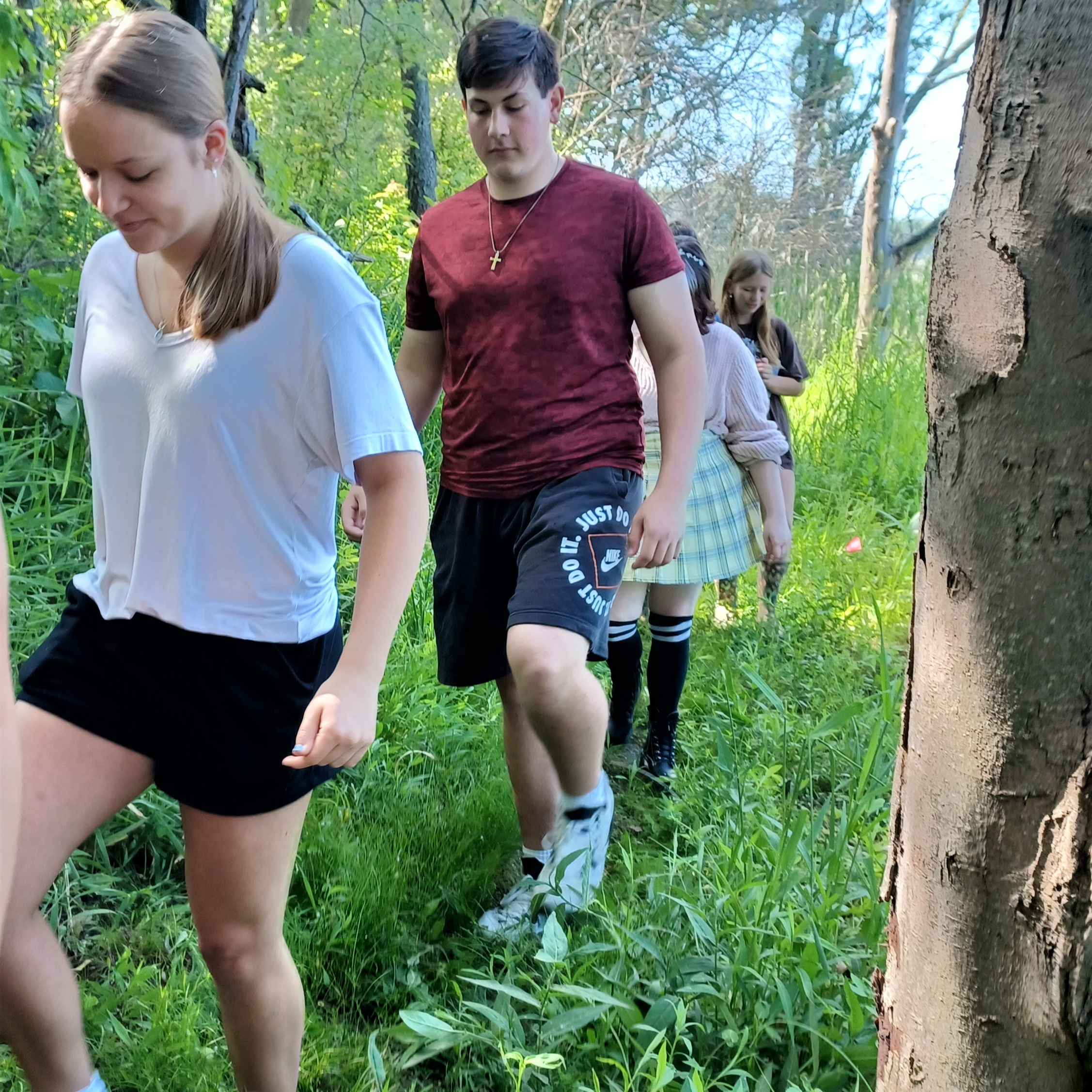 High school students hiking through the Delton Kellogg Outdoor Learning Space.