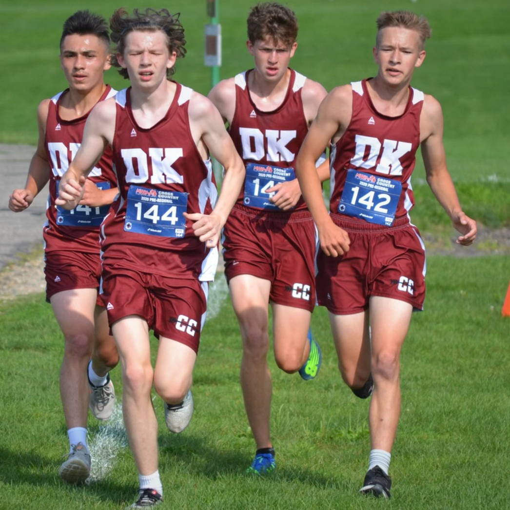 Four Delton Kellogg High School students running cross country.