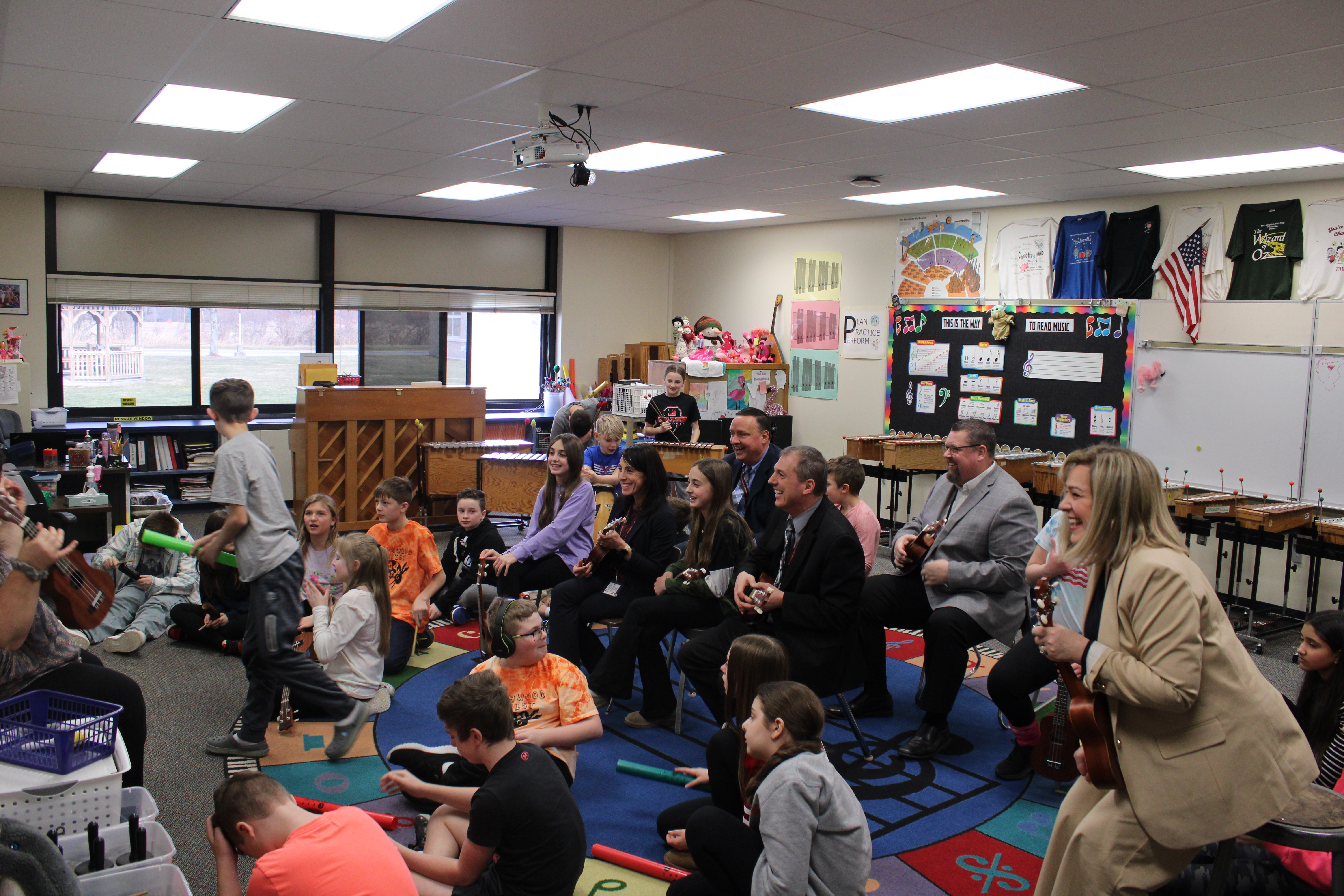 Dr. Casey Kosiorek playing instruments with students