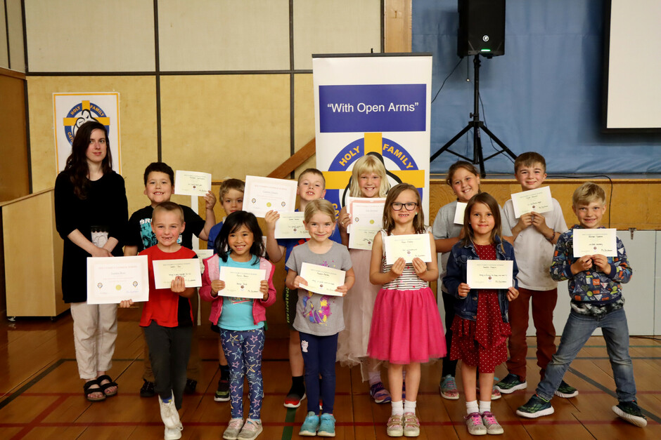 Holy Family - Students standing with certificates