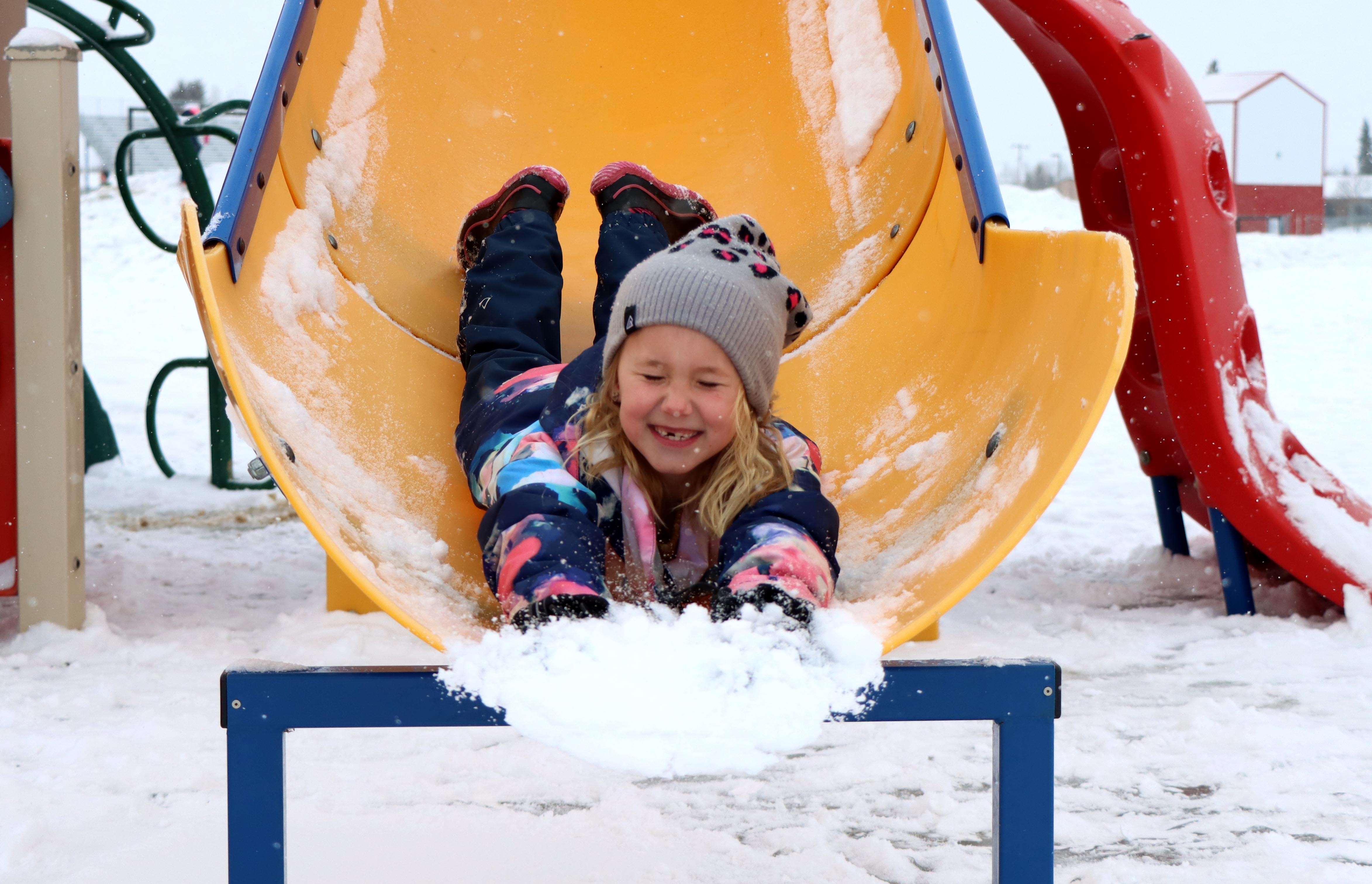 Little girl on slide smiling