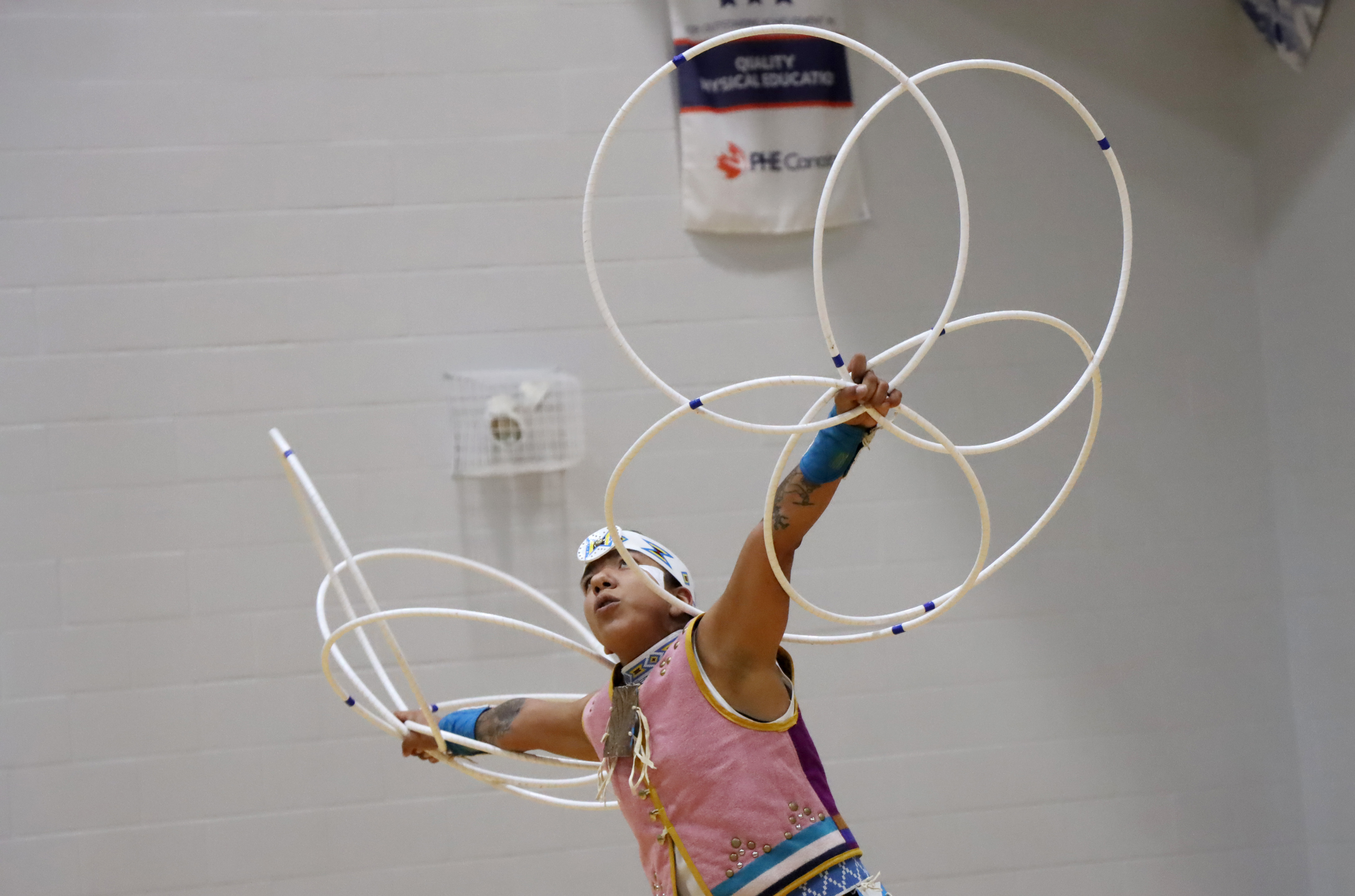 Indigenous dancer holding hoops in the air