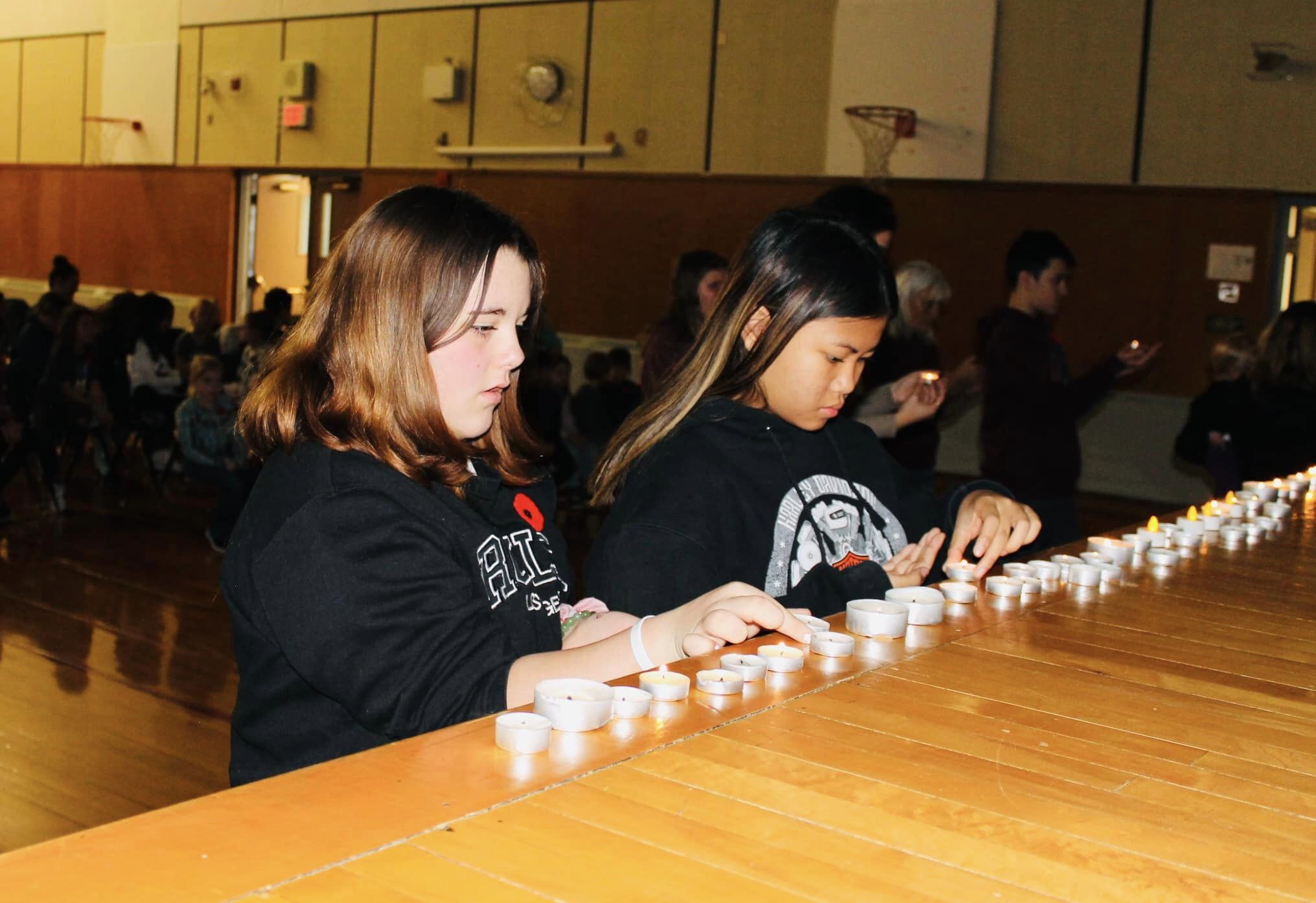Students lighting candles