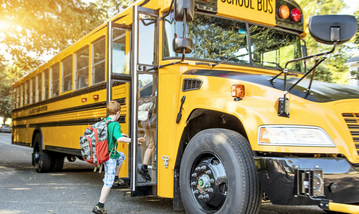 Student boarding a school bus