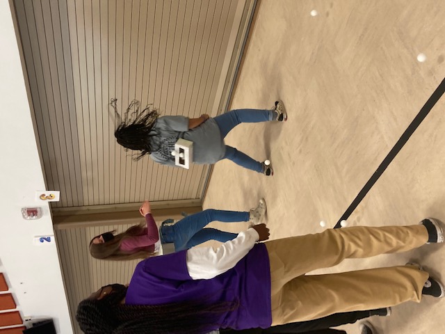 girl completing ice breaker activity involved box and ping pong balls