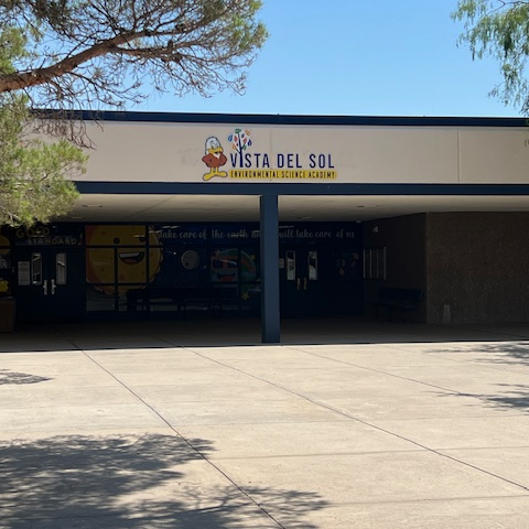 image of the front of a building with trees in front of it