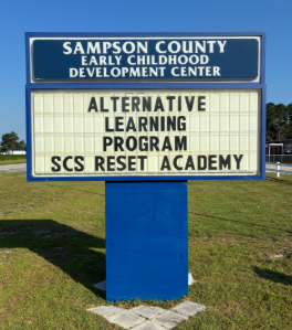 Picture of sign at the Sampson County Early Childhood Development Center where the Alternative Learning Program is for Sampson County Schools, Reset Academy