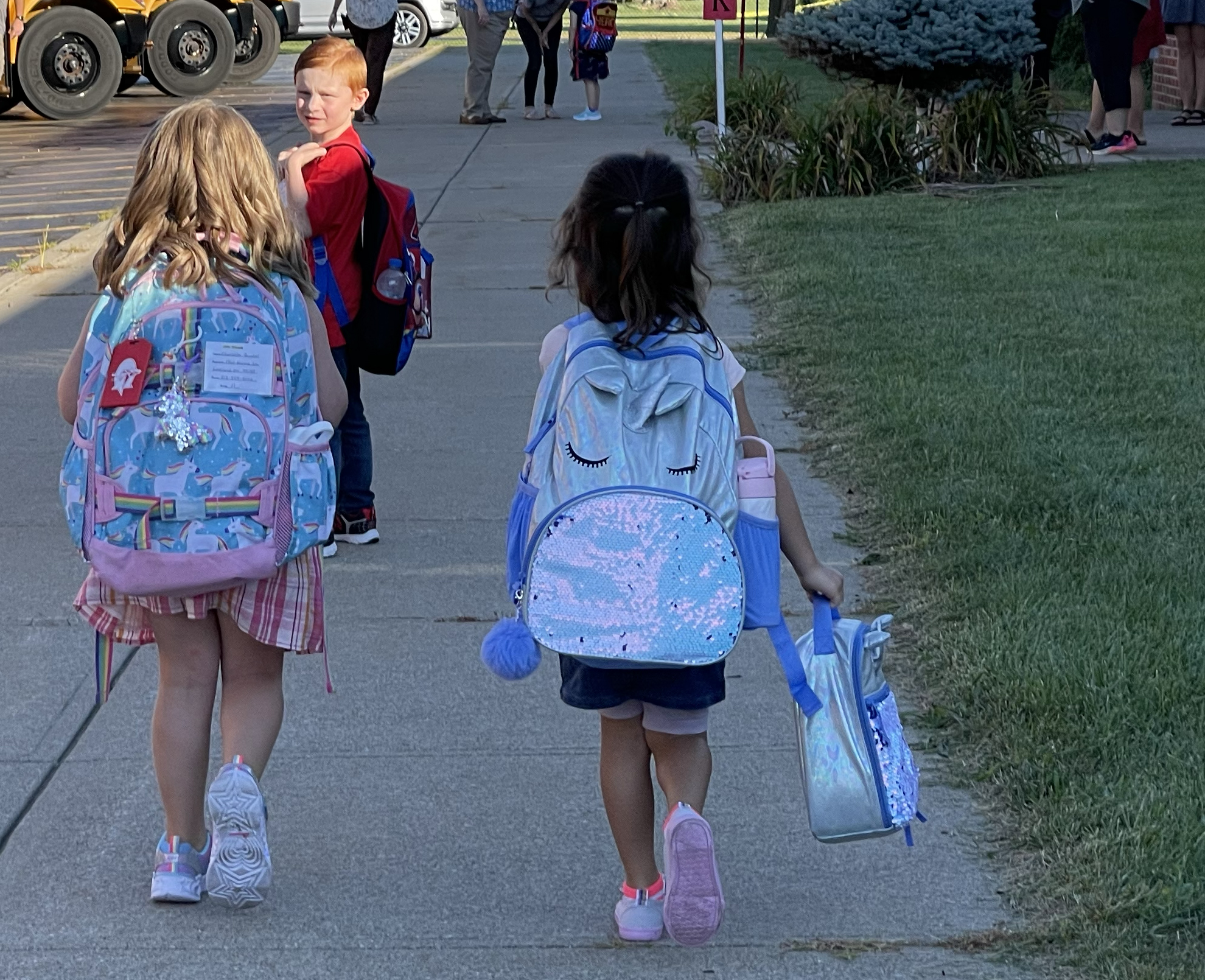 Young students wearing backpacks