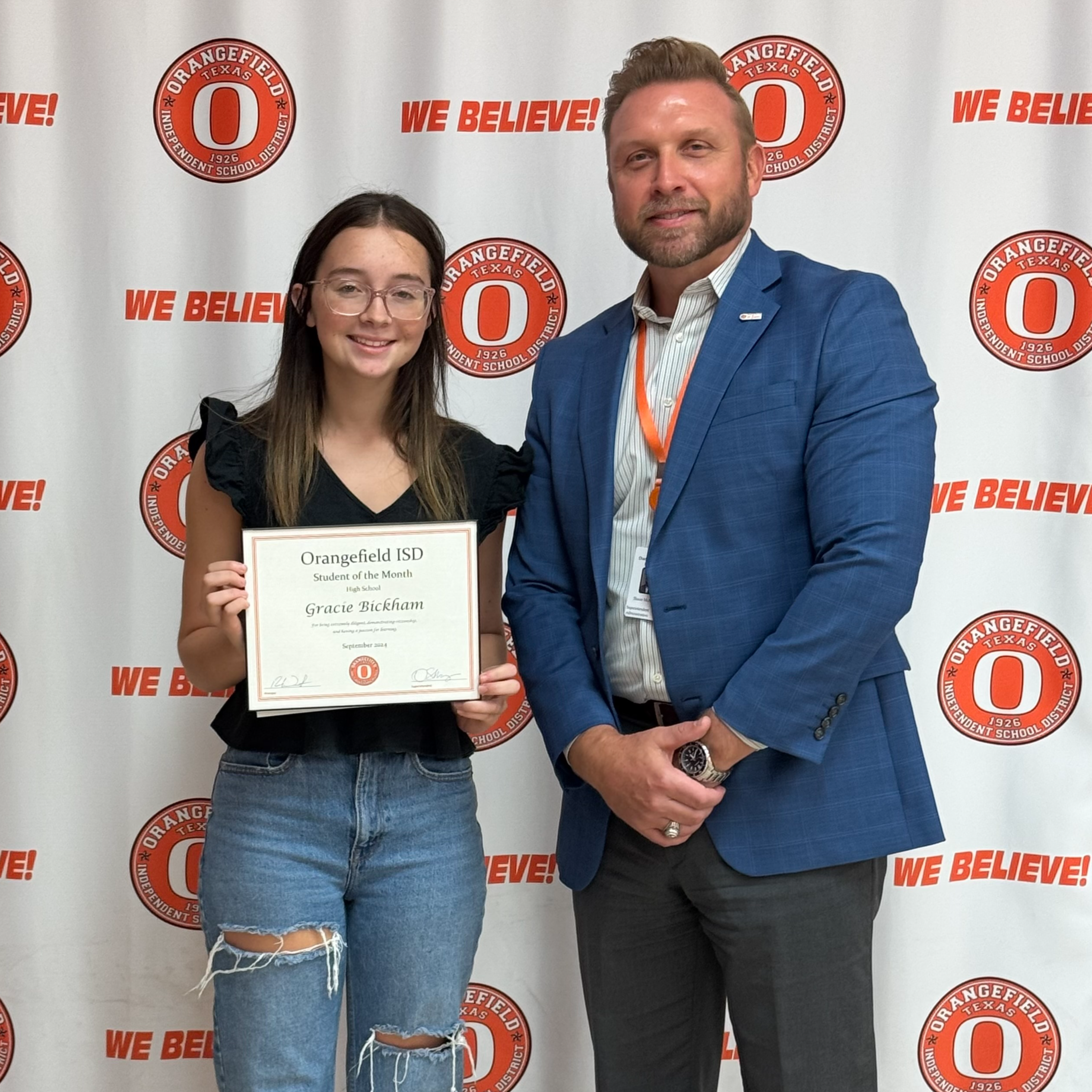 student holding awards