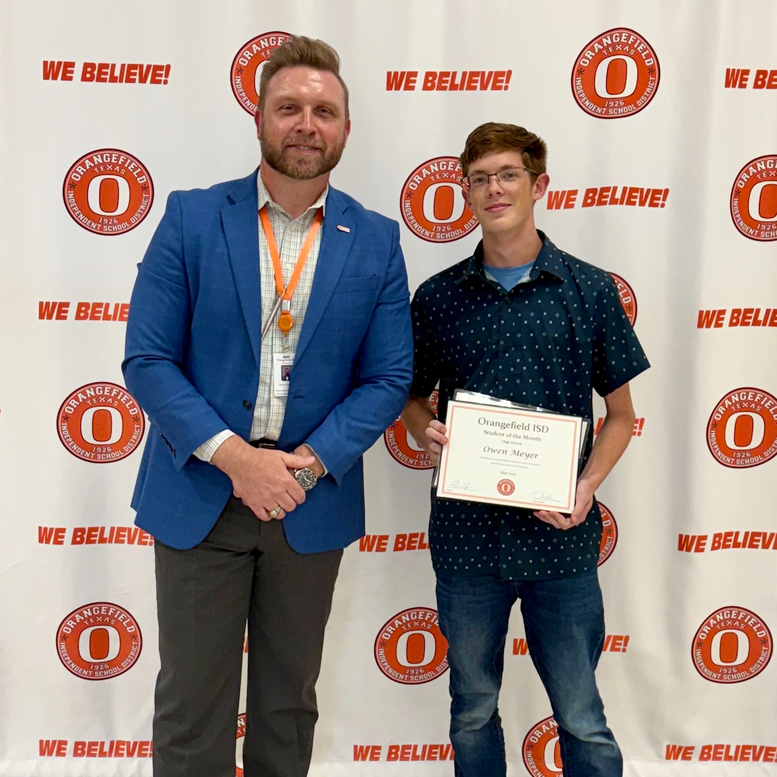 student holding awards