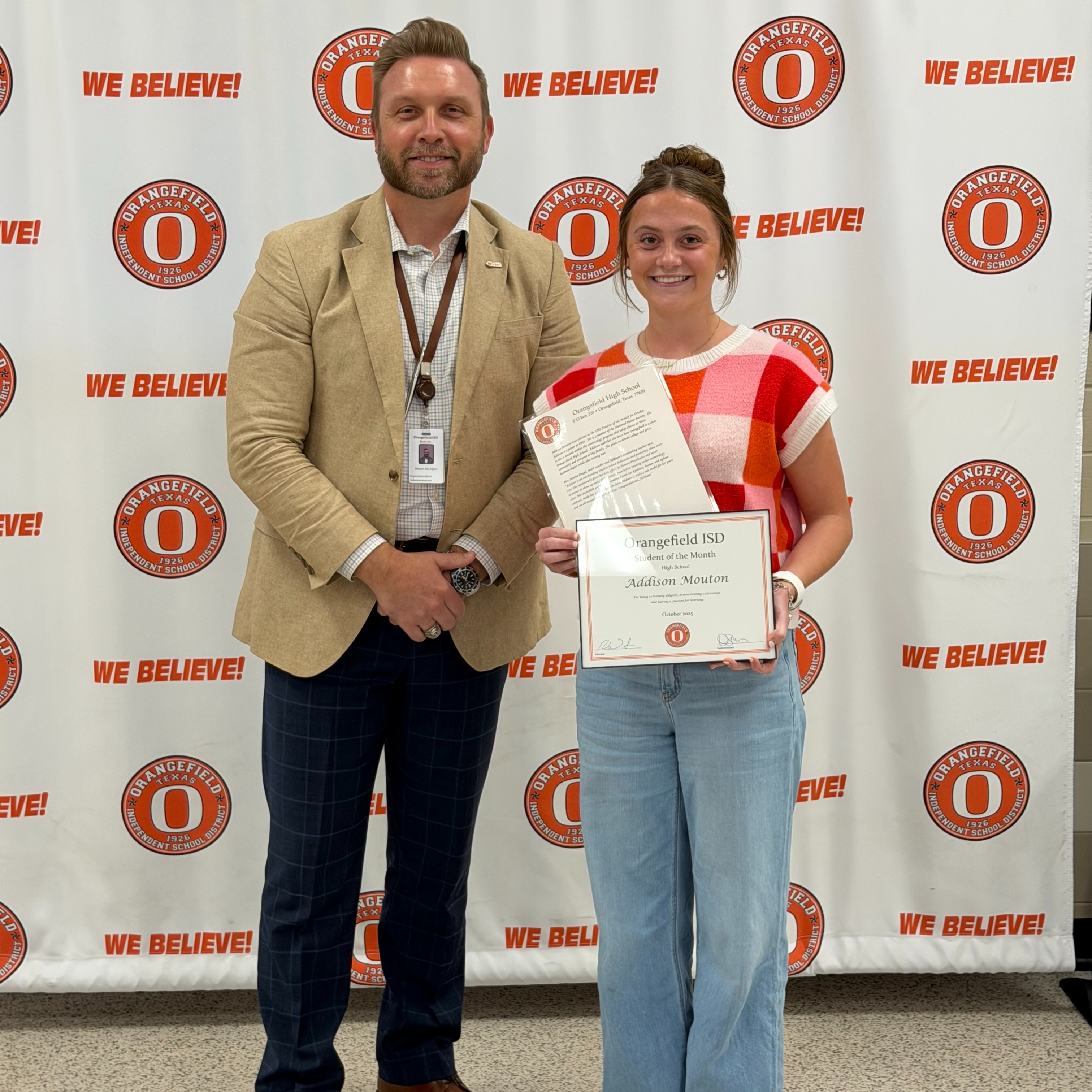 student holding awards