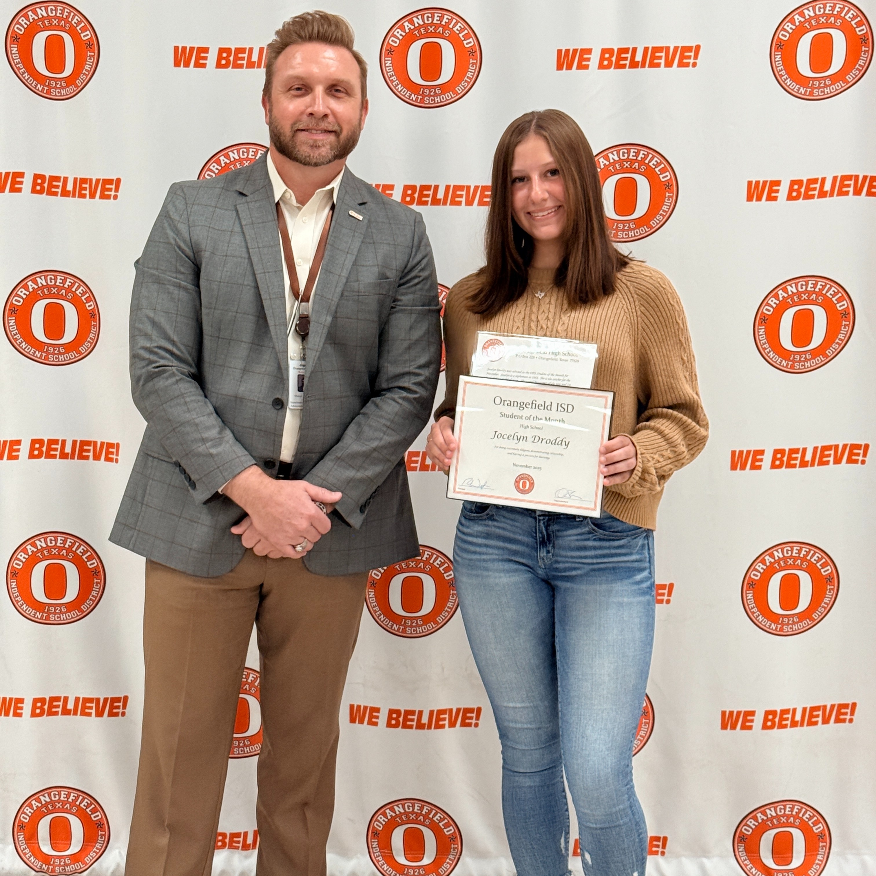 student holding awards