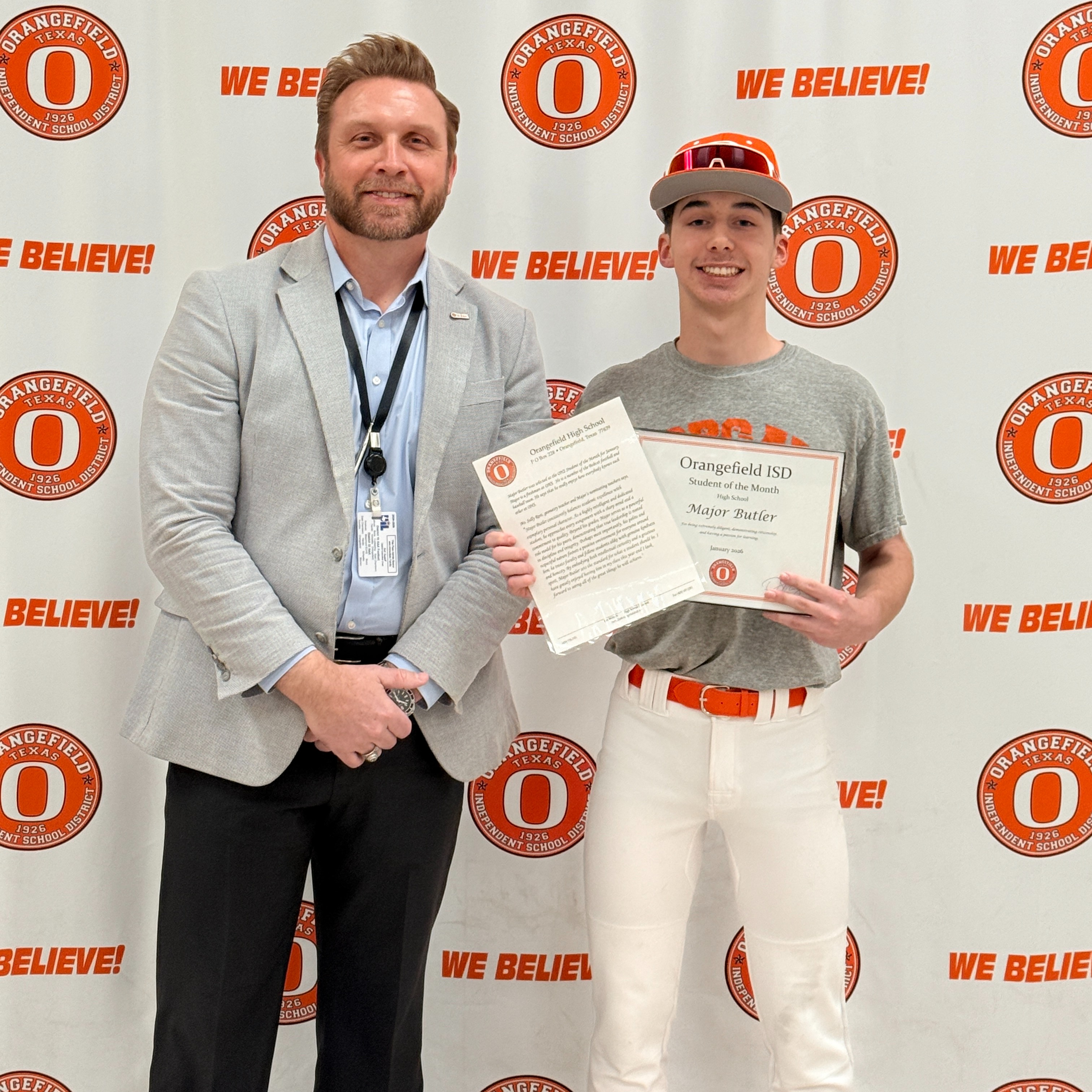 student holding awards