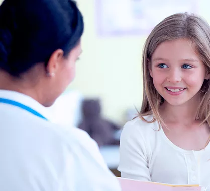 Young girl looking at doctor