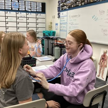 Sultan High School students in health science class practicing hearing heartbeats on each other