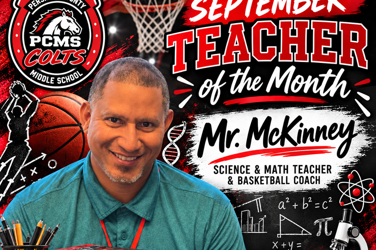 A man smiles, seated at a desk with science and math books. Text reads "September Teacher of the Month Mr. McKinney."