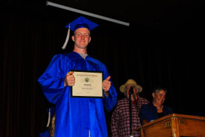 Graduating Senior posing with Diploma