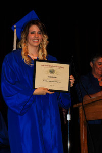 Graduating Senior posing with Diploma