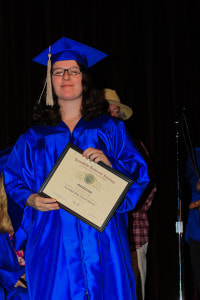Graduating Senior posing with Diploma