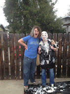 2 staff members having fun on pi day. One has pie all over herself