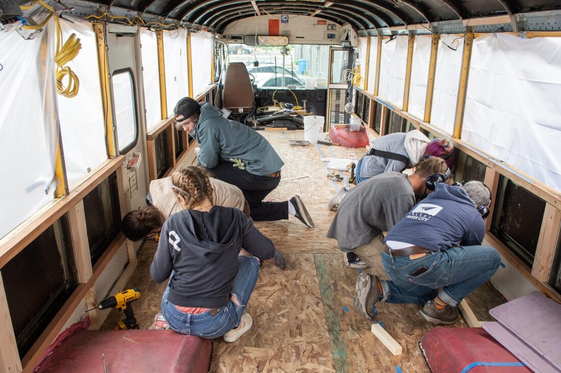 Students fixing up a bus