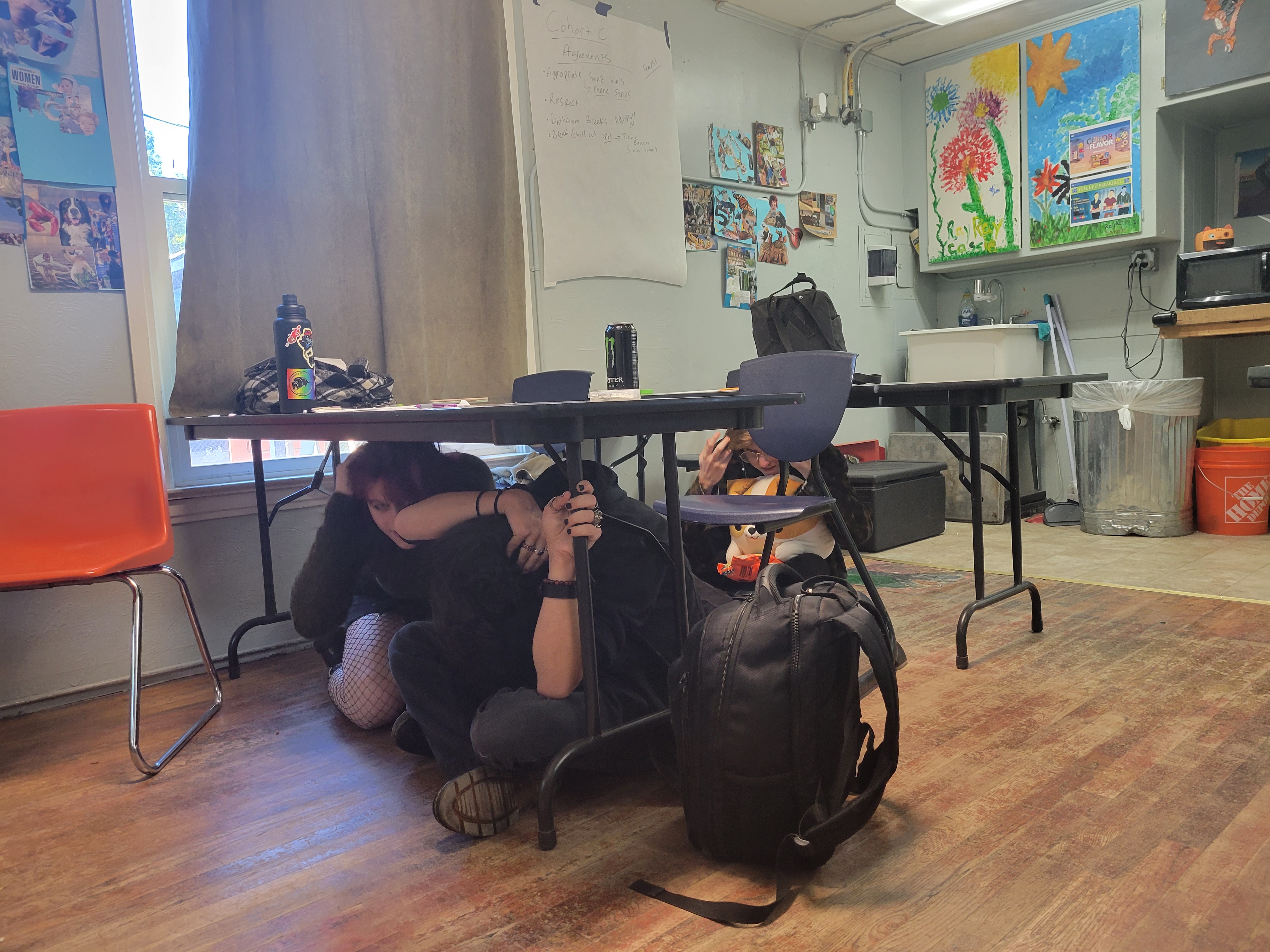 Students under desk 