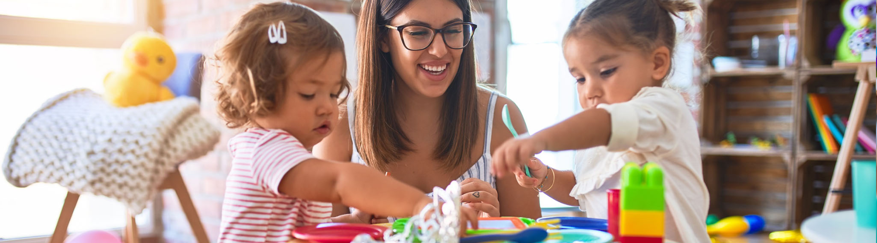 image of an adult and two toddlers at a table