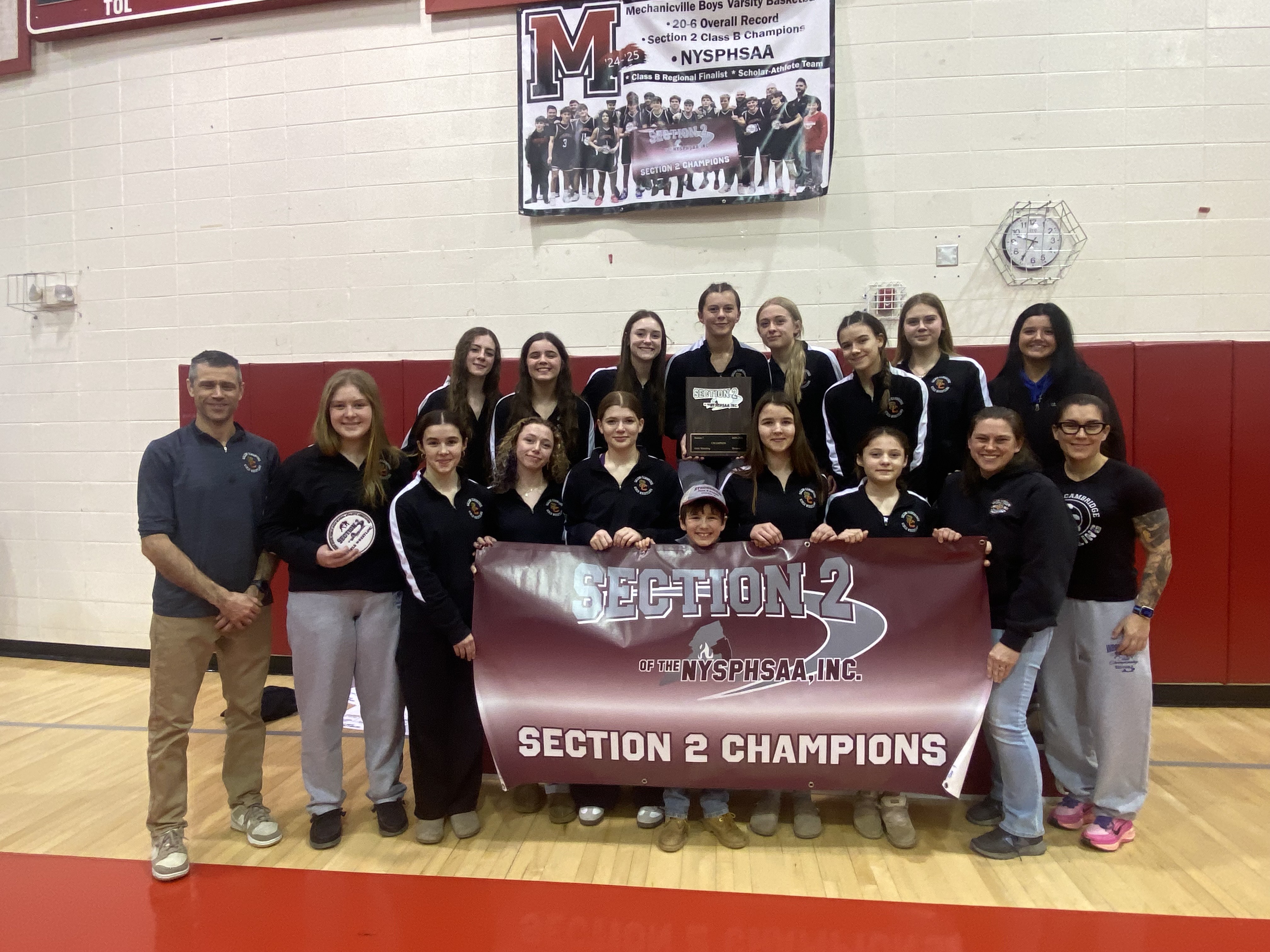 photo of wrestling team with banner reading "Section 2 Champions"
