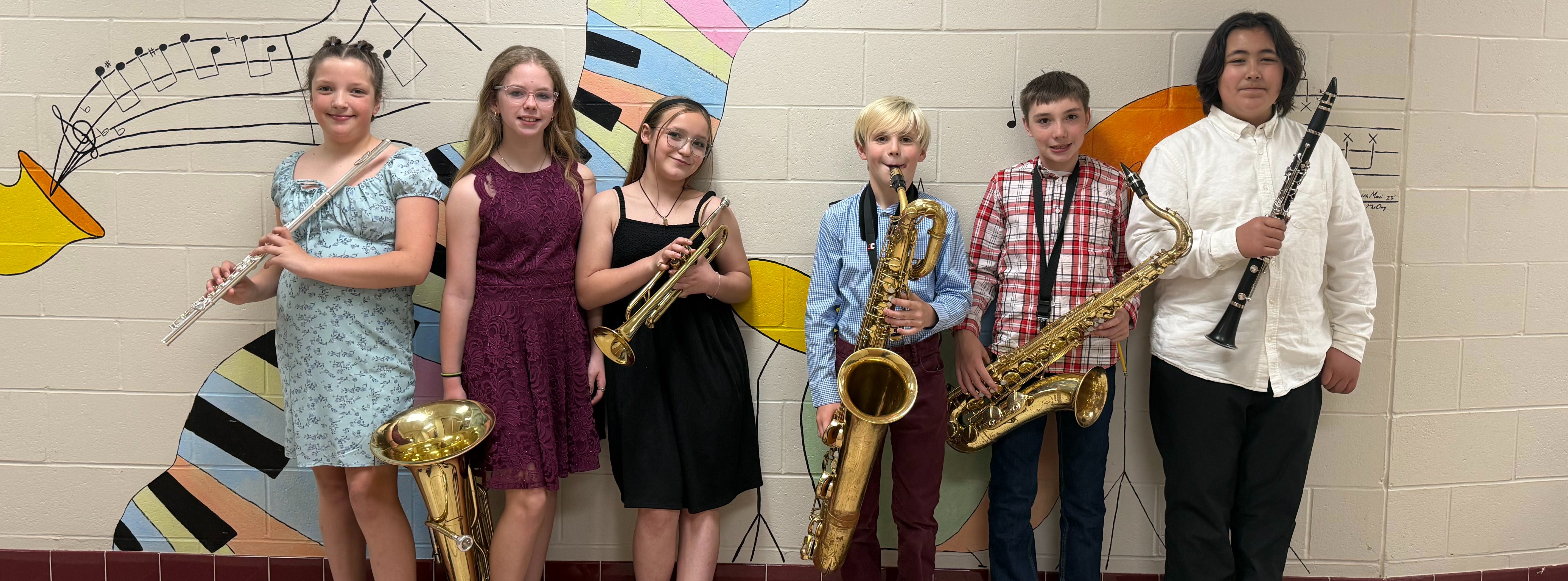 photo of student-musicians with their respective instruments.