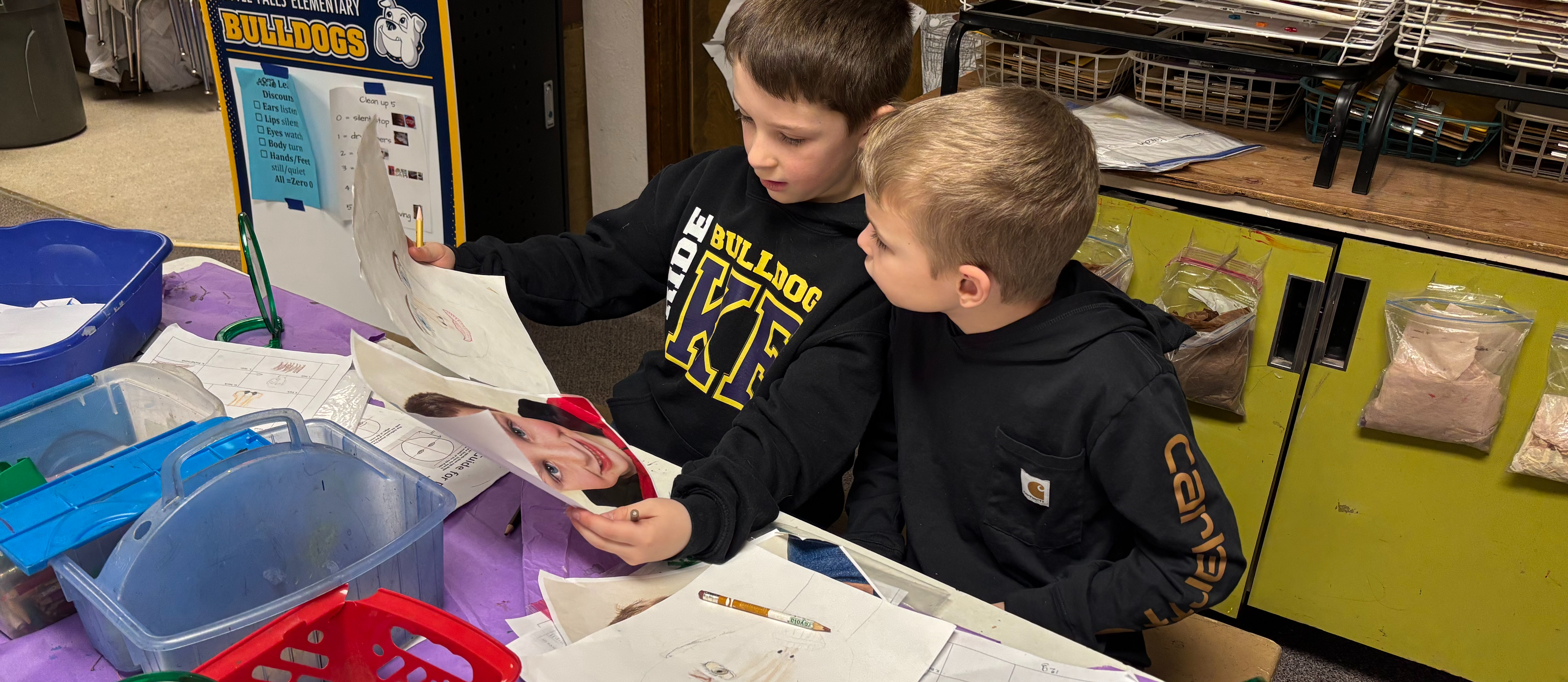 students looking at their artwork