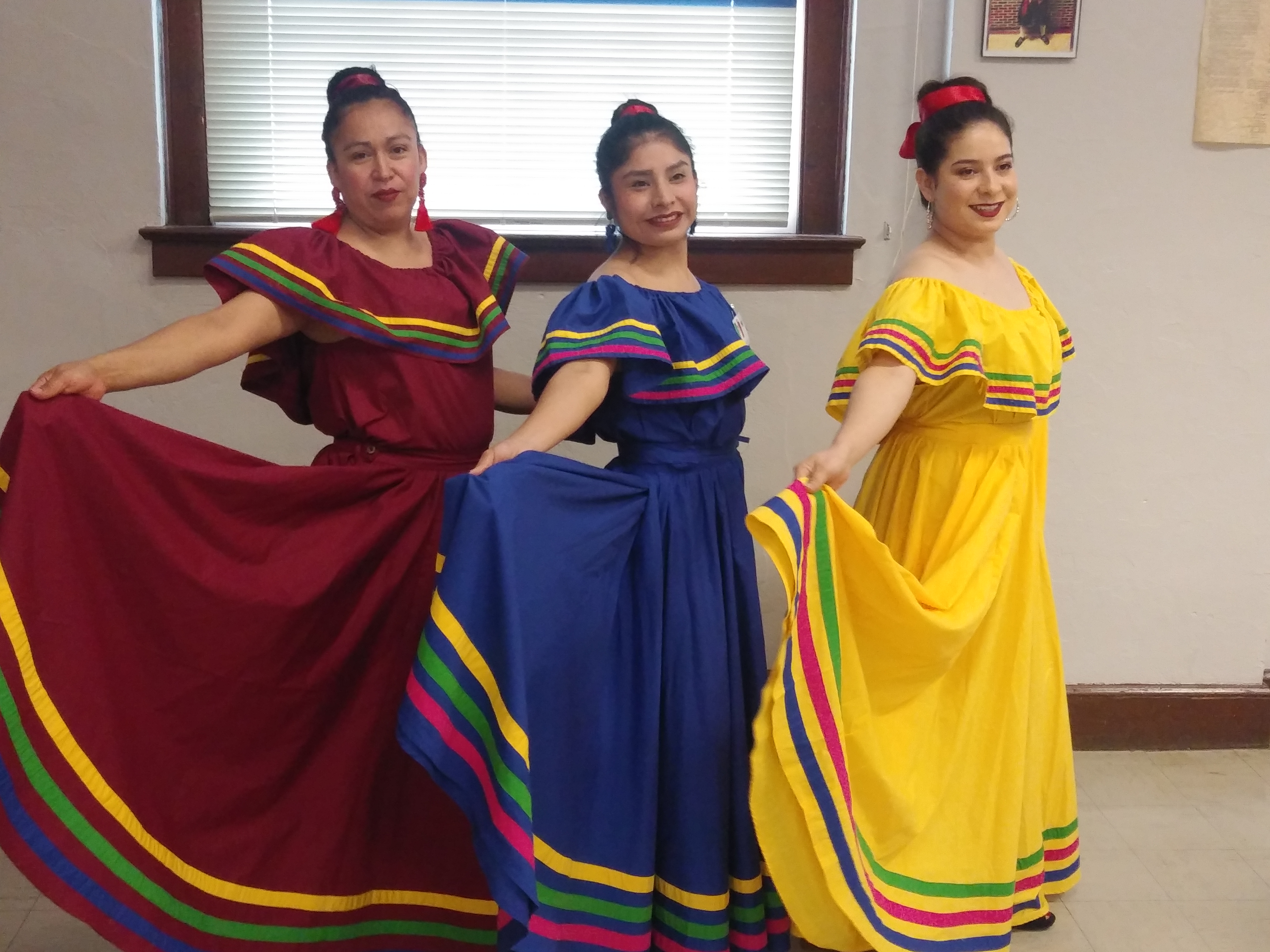 Three ladies in mexican festival dresses