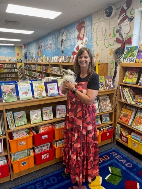 librarian and Dewey the library bunny with library background