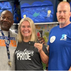 Mr. Hunt Ms. Grider and Jason from Blue Cross and Blue Shield with the gift card that will buy all the students in our school a book at the book fair