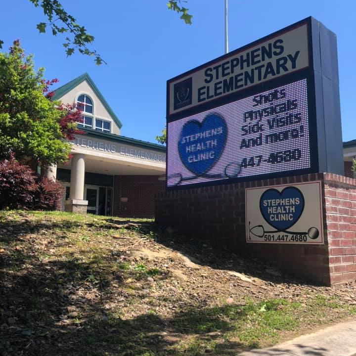 Marquee outside of building displaying clinic logo and phone number 501-447-4680.