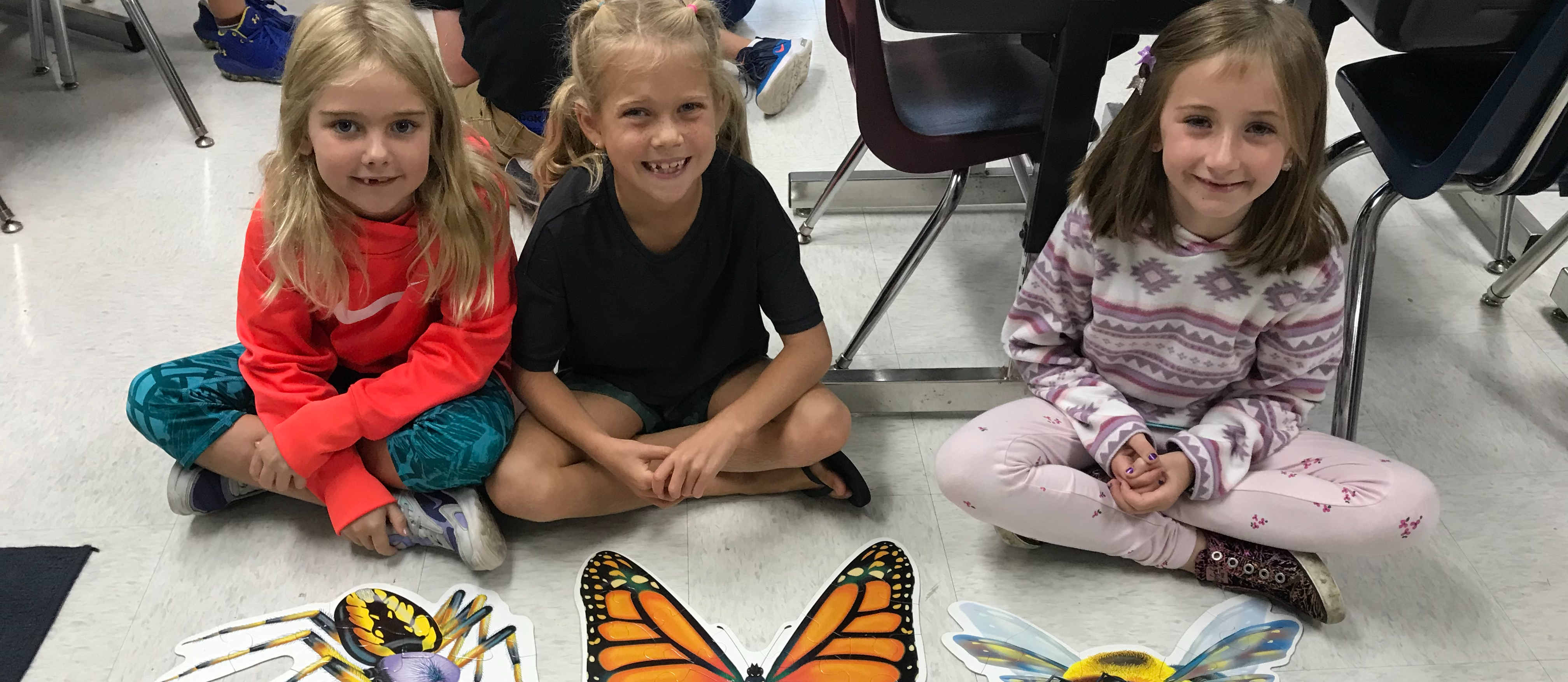 three students by a butterfly