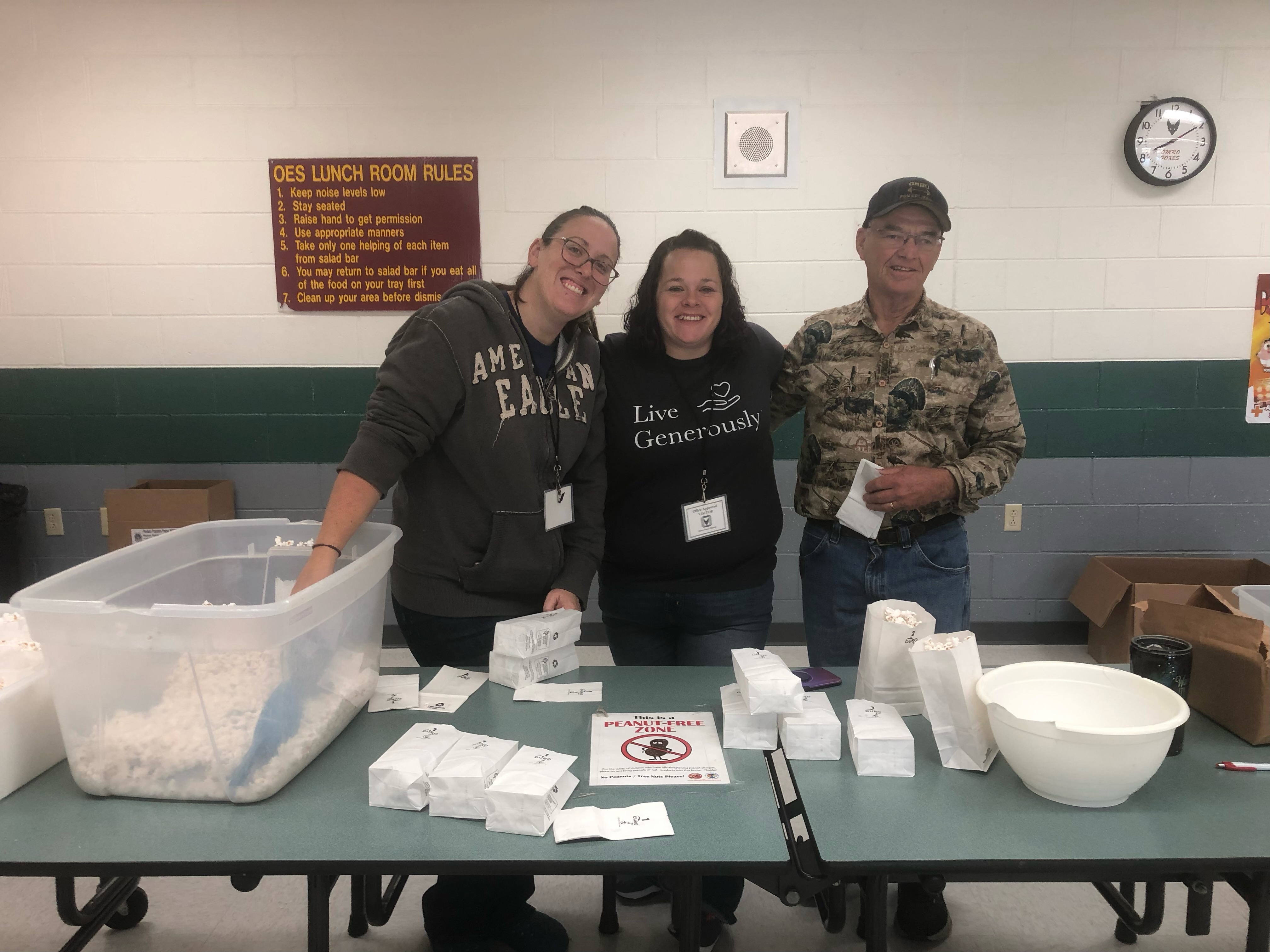 Staff posing at the popcorn table