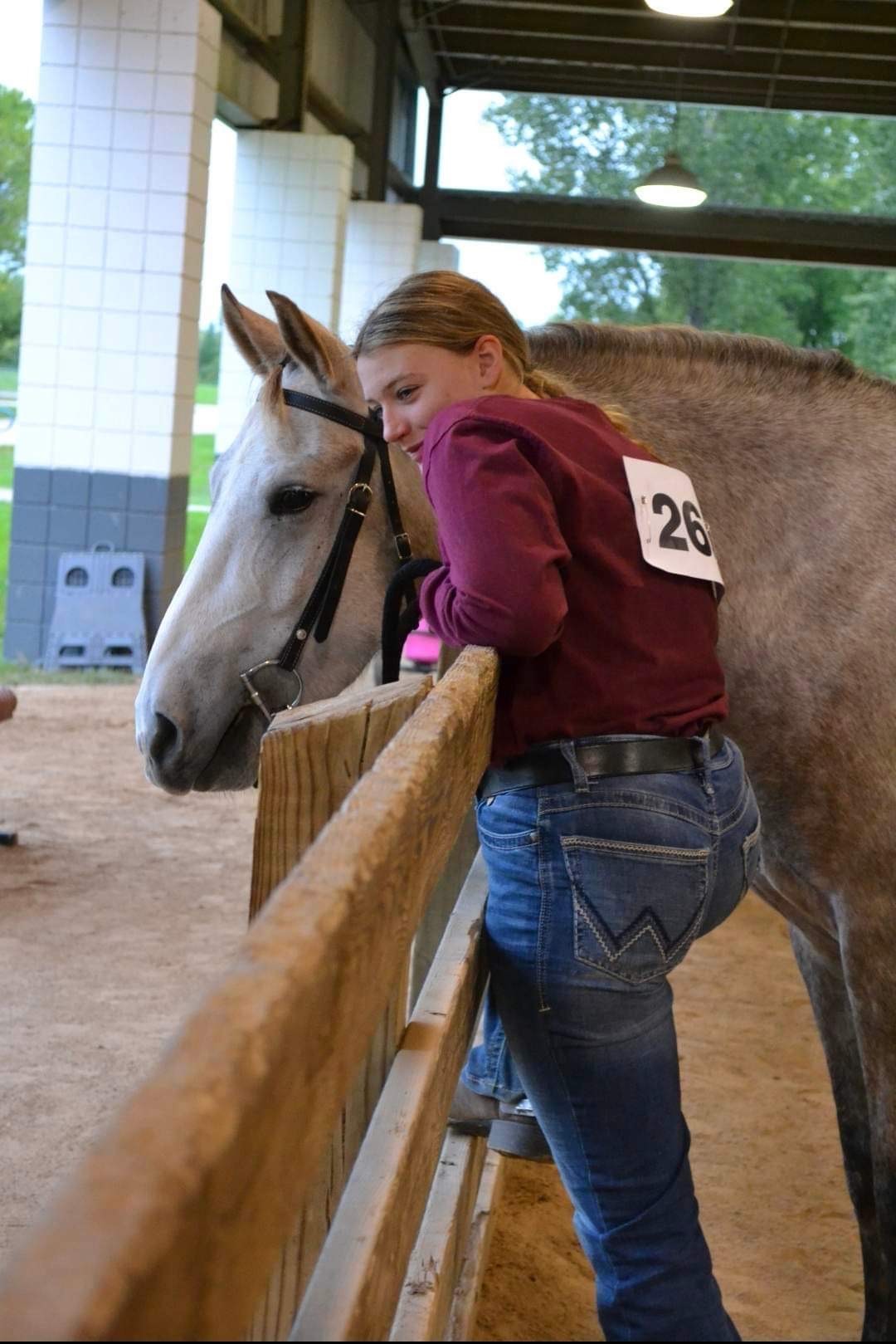 Girl hugging a horse.