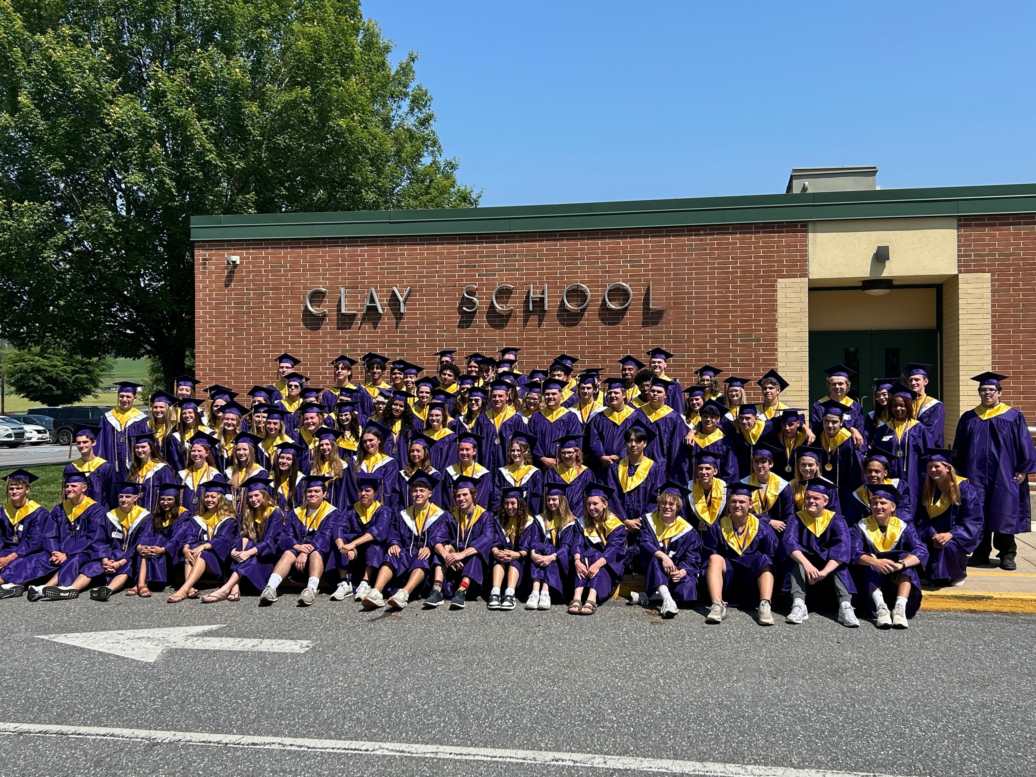 High School graduates under the Clay Elementary sign